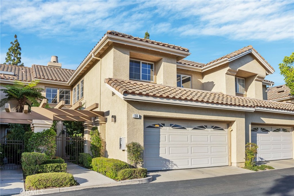 Two-Story Beige House with Garage in Real Estate Listings