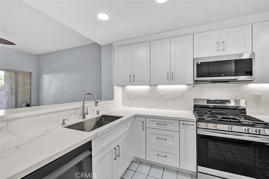 Modern Kitchen with White Cabinets and Marble Countertops in Real Estate Listing