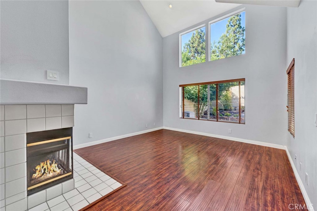 Spacious Living Room with Fireplace and Large Windows in Real Estate Listing