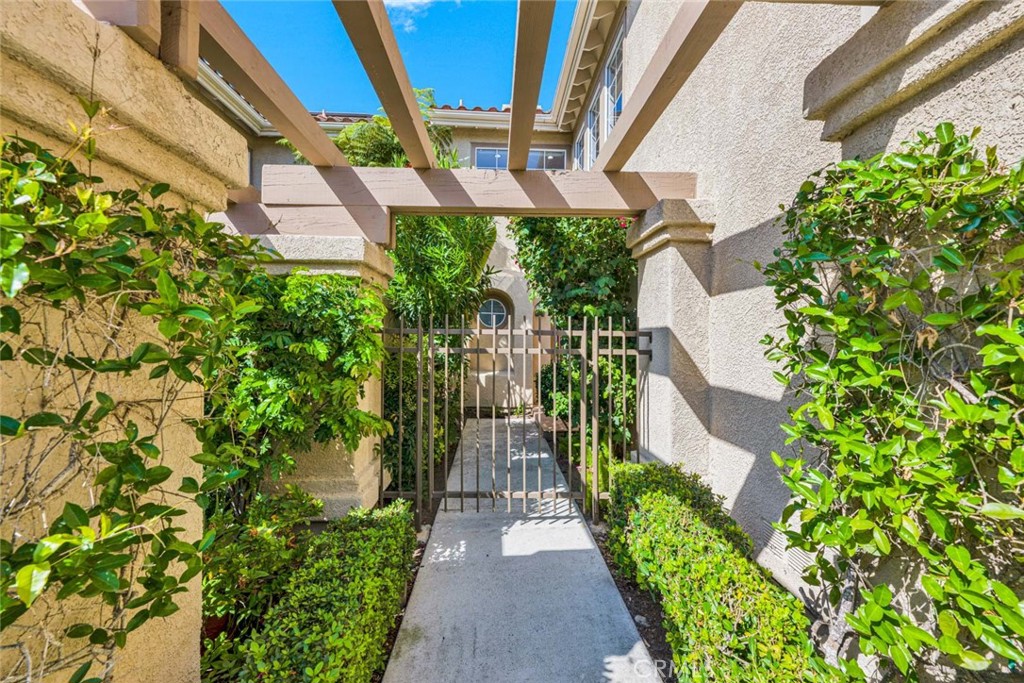Garden Entrance with Wooden Pergola Leading to a Home for Sale