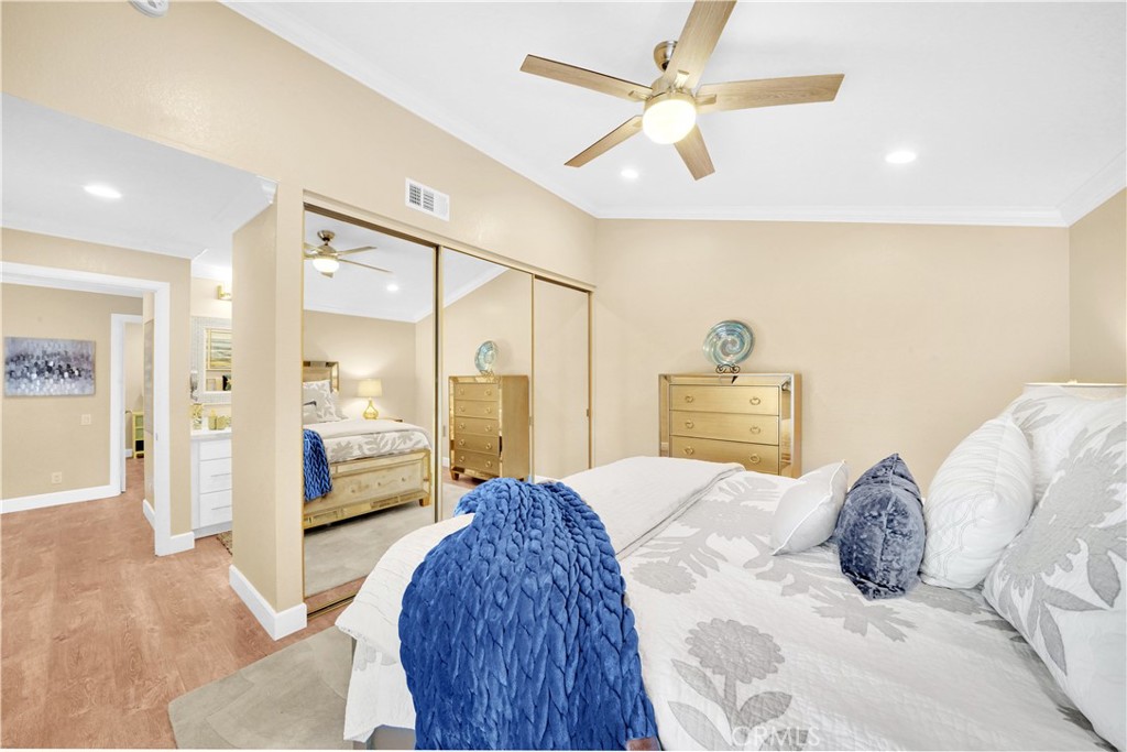 Modern Bedroom with Stylish Decor and Ceiling Fan in Real Estate Listing