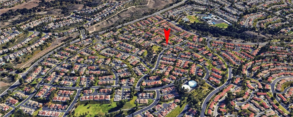 Aerial View of Suburban Neighborhood with Homes for Sale Marked by Arrow