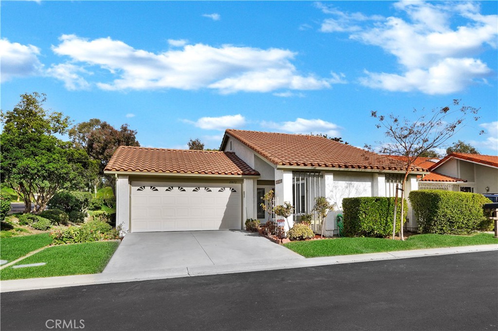 Single-Story Home With Red Tile Roof and Well-Maintained Front Yard