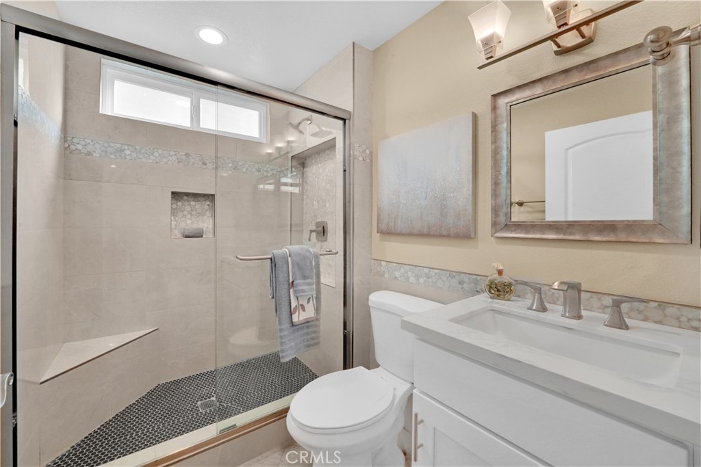 Modern Bathroom with Glass Shower and Elegant Fixtures in Real Estate Listing