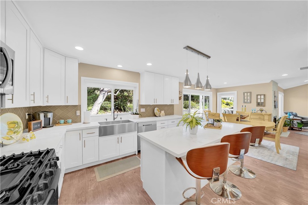 Modern Kitchen With White Cabinets and Island in Real Estate Listing