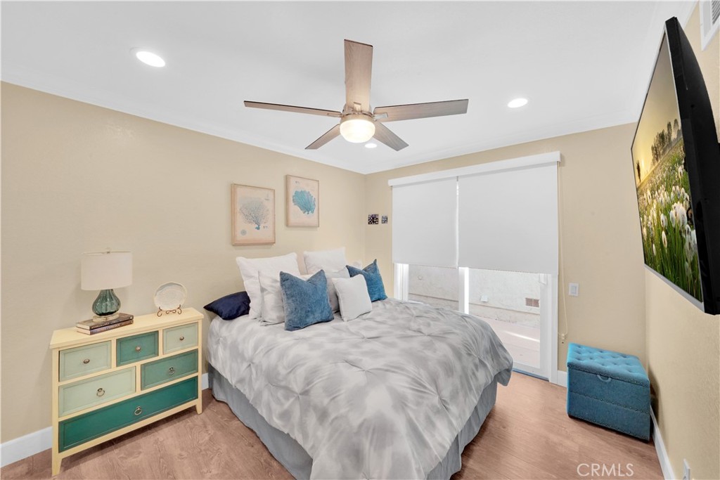 Bedroom with Modern Ceiling Fan and Elegant Bedding, Featuring Real Estate Listings
