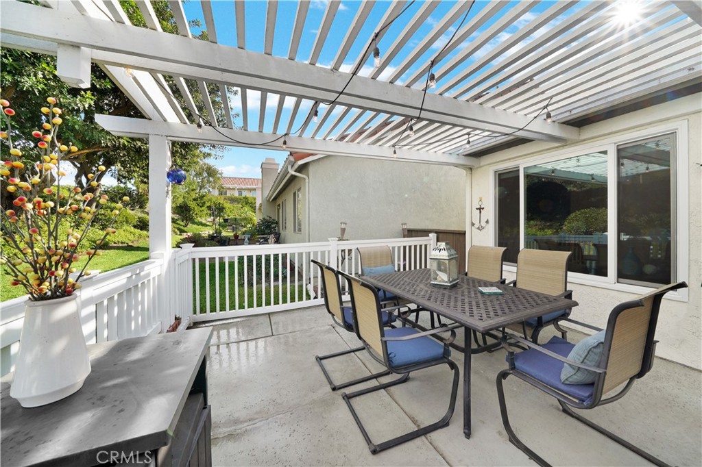 Spacious Backyard Patio with Outdoor Dining Set and Garden View