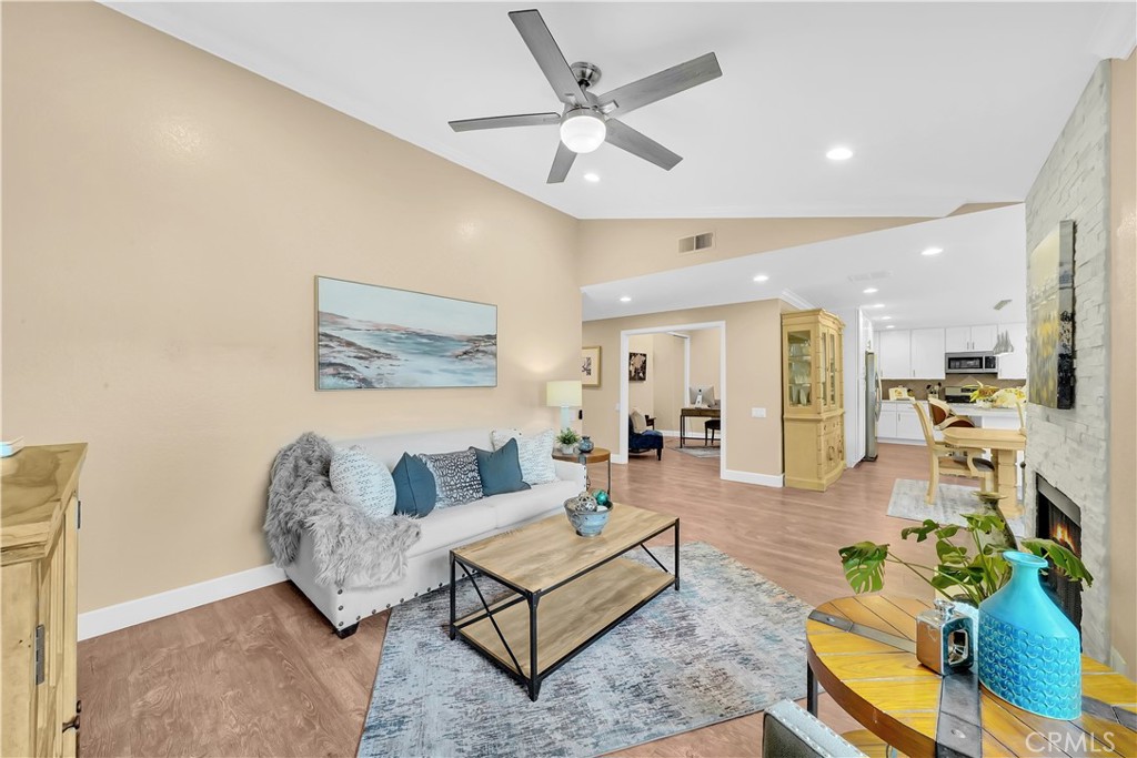 Spacious Living Room with Modern Decor and Ceiling Fan in Real Estate Listing