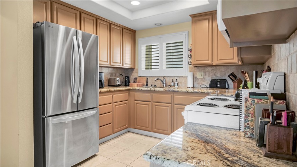Modern Kitchen with Wooden Cabinets and Stainless Steel Refrigerator