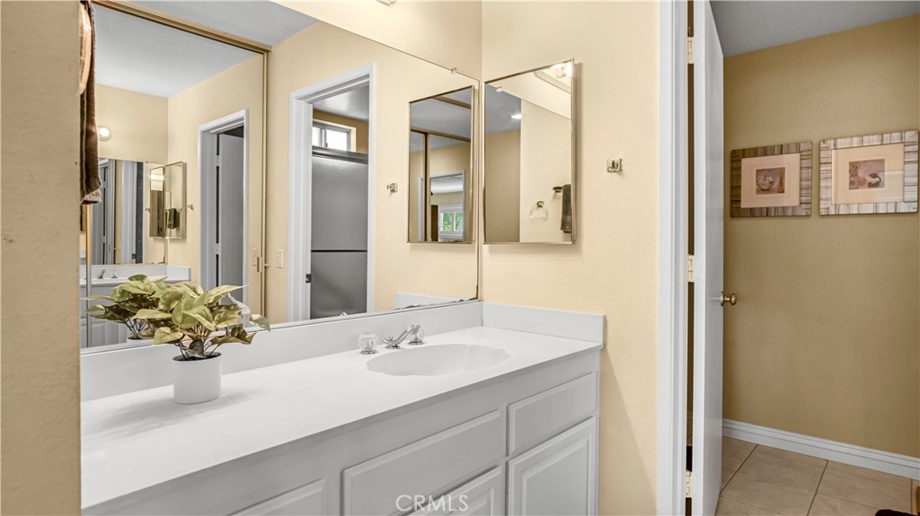 Spacious Bathroom Sink Area with Large Mirror in Real Estate Listing
