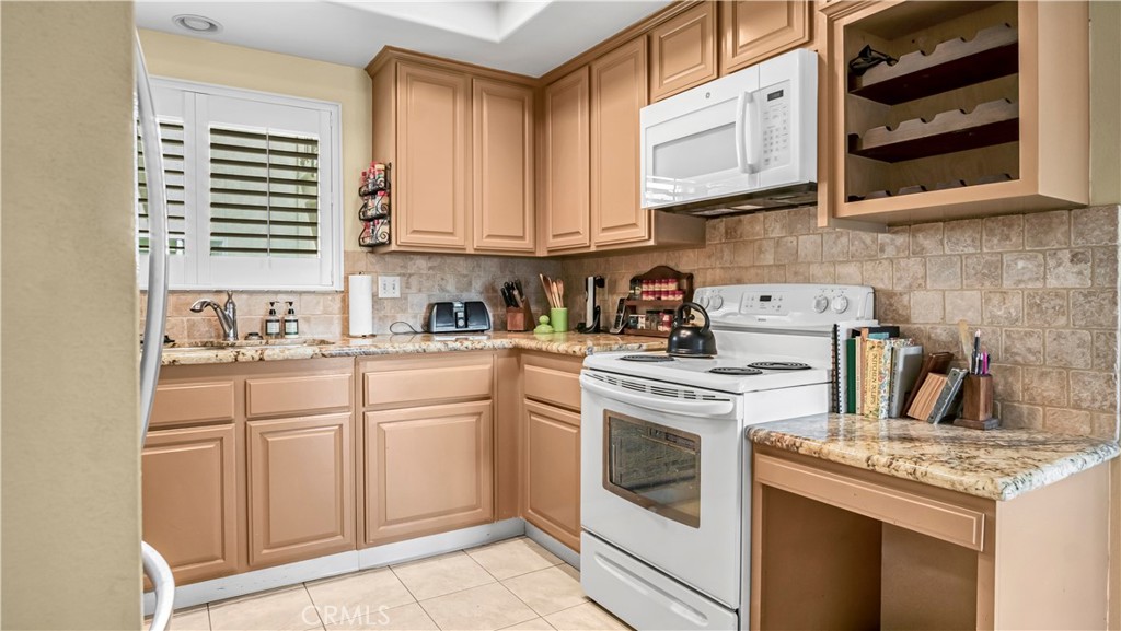 Modern Kitchen with Wooden Cabinets, Granite Countertops, and Appliances in Real Estate Listing