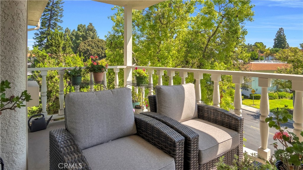 Outdoor Patio with Wicker Chairs Overlooking Greenery and Trees