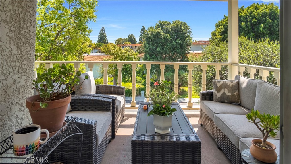 Cozy Outdoor Patio with Wicker Furniture Overlooking Lush Greenery