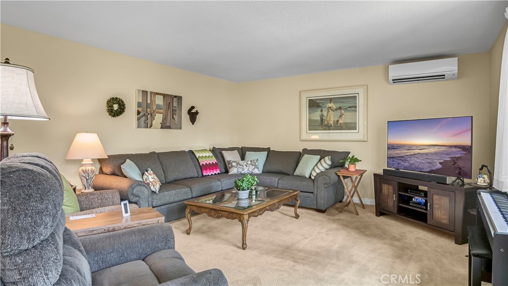 Spacious Living Room with Comfortable Sofa and TV in Real Estate Listing