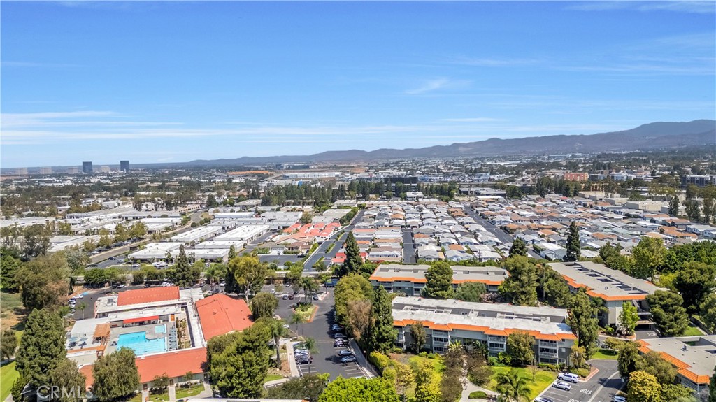 Aerial View of Residential Neighborhood and Real Estate Listings with Distant Hills
