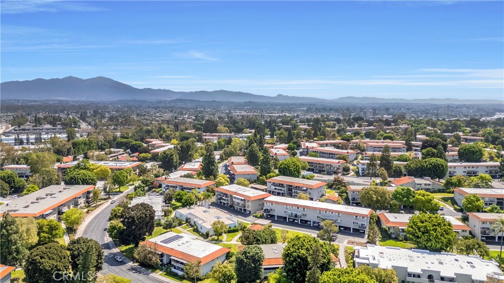 Aerial View of Residential Complex Under Clear Blue Sky with Mountains