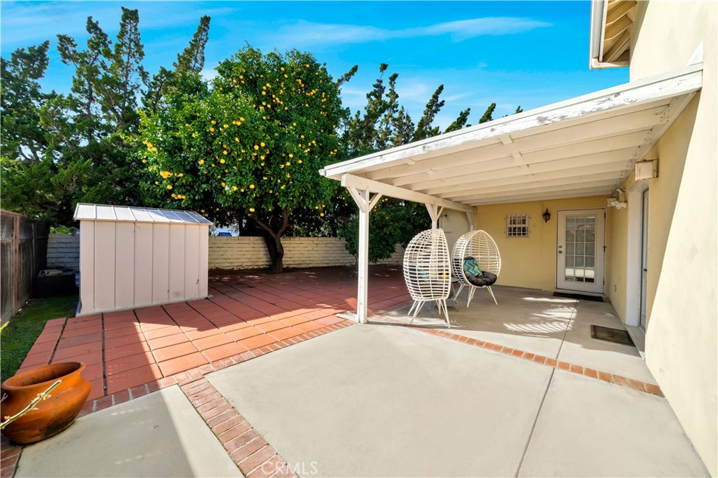 Backyard Patio With Orange Tree and Covered Seating Area, Real Estate Listings