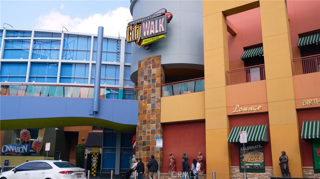 Colorful Urban Buildings with Signage and People Walking Nearby