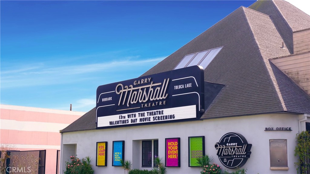 Garry Marshall Theatre Exterior with Vibrant Posters and Clear Blue Sky