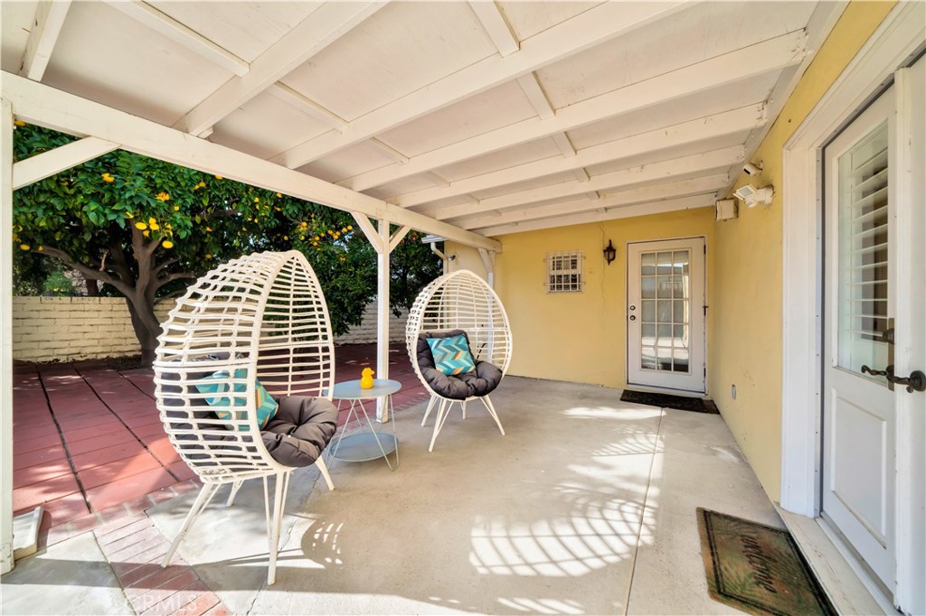 Covered Patio with Egg Chairs Near Backdoor of Real Estate Property