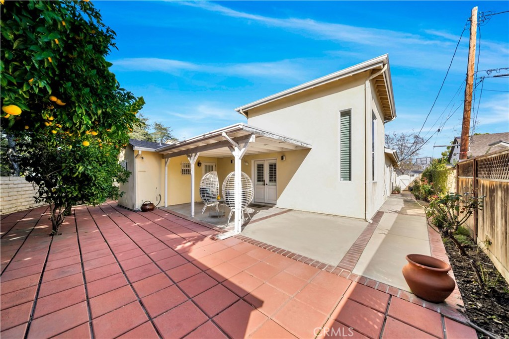 Backyard of Single-Family Home with Patio and Potted Plants
