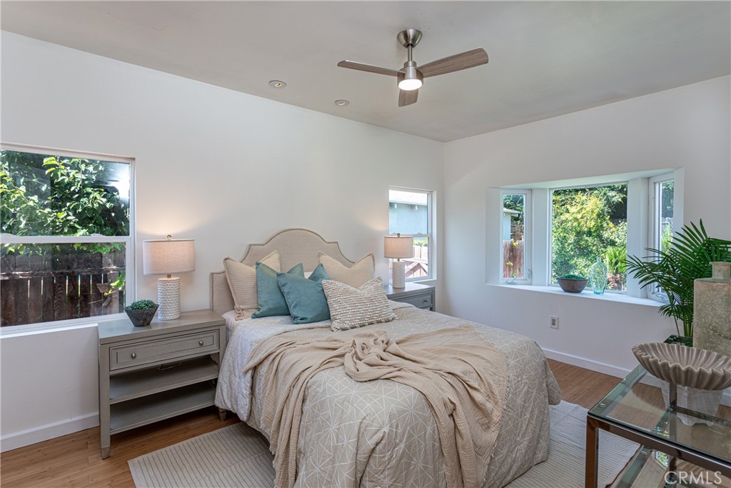 Spacious Bedroom with Elegant Furnishings and Large Windows in Homes for Sale