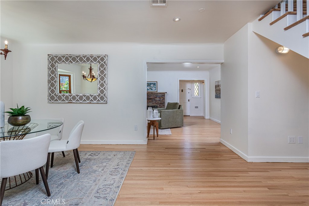 Modern Living and Dining Area in Real Estate Listing with Wooden Flooring