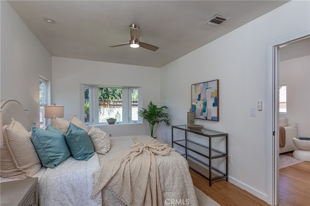 Bedroom with Modern Decor and Art, Featuring a Ceiling Fan