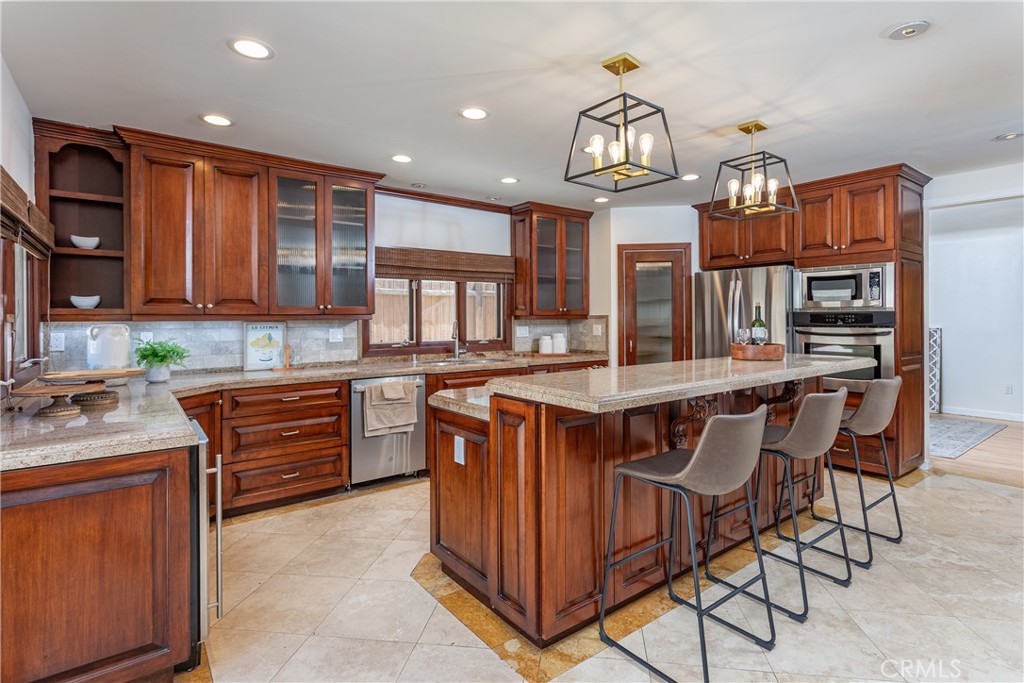 Spacious Kitchen with Wooden Cabinets and Island in Homes for Sale Listing