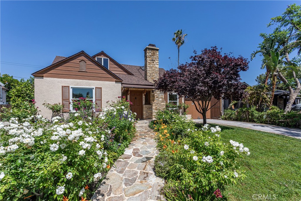 Charming Home with Lush Garden and Stone Pathway Real Estate Listing