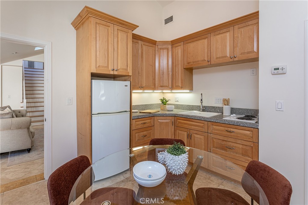 Cozy Kitchen Corner with Wooden Cabinets and Real Estate Listings Decor