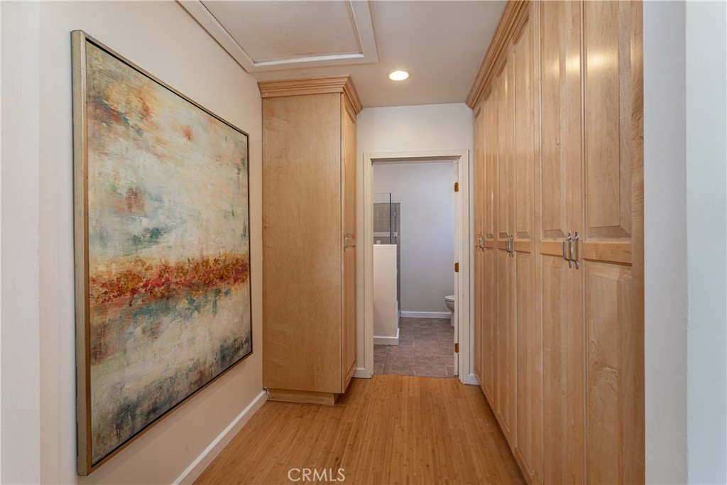 Hallway with Wooden Cabinets and a Colorful Abstract Painting