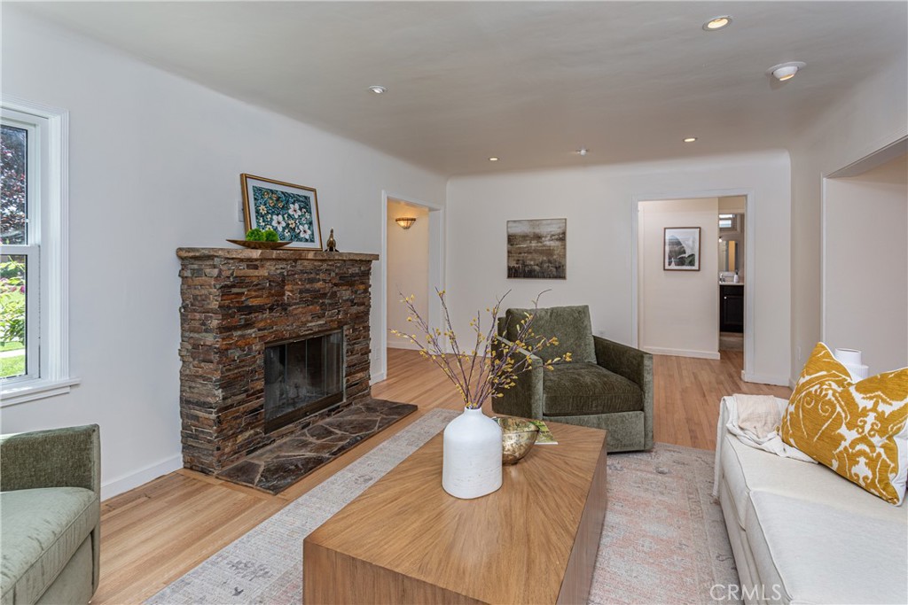 Spacious Living Room with Stone Fireplace and Elegant Real Estate Decor