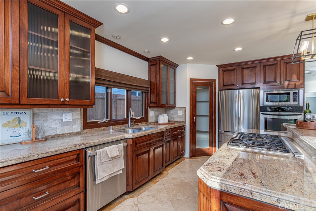 Spacious Kitchen With Granite Countertops and Wooden Cabinets in Real Estate Listing