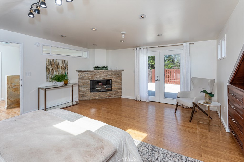 Modern Bedroom with Fireplace and Access to Spacious Patio, Real Estate Highlight