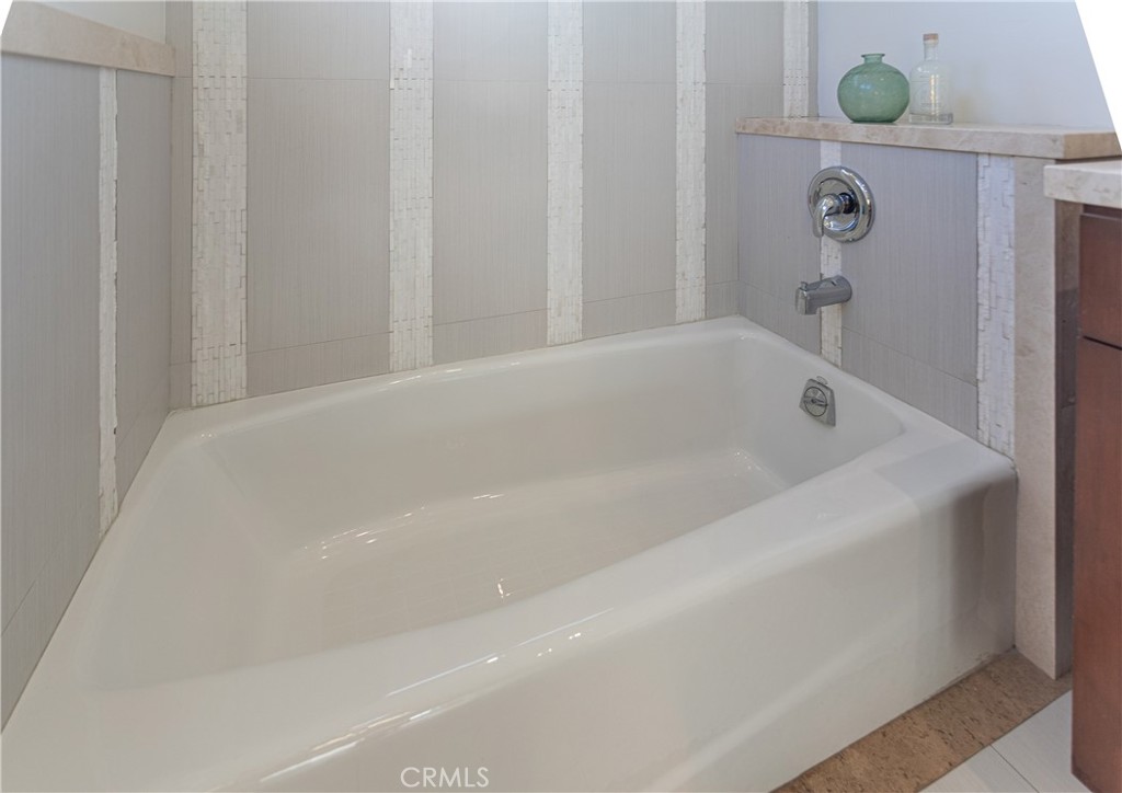 Modern Bathroom With White Bathtub and Elegant Tile Design