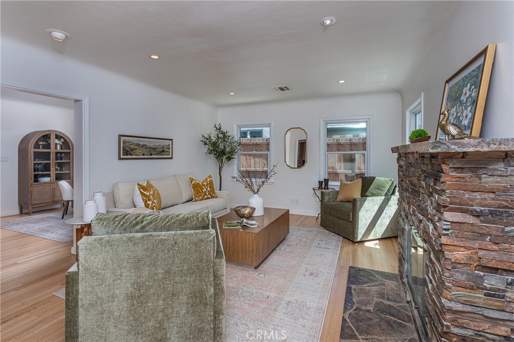 Spacious Living Room with Modern Decor and Stone Fireplace in Real Estate Listing