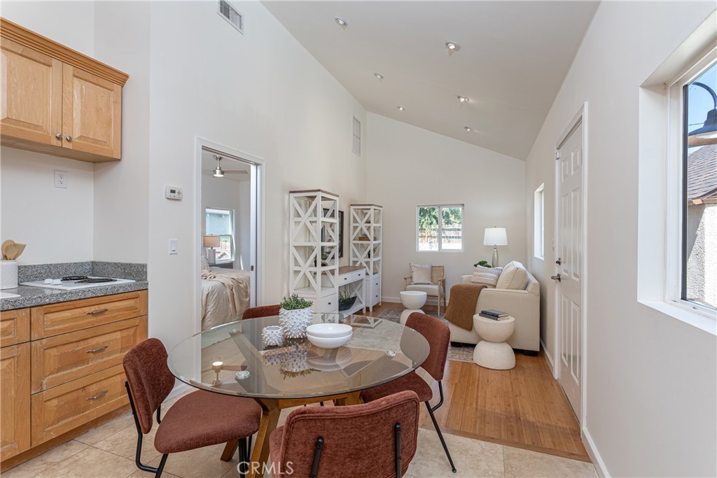 Dining Area with Wooden Table and Comfortable Living Room in Real Estate Listing