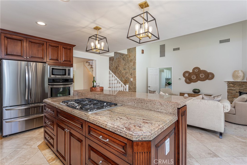 Modern Kitchen with Granite Island and Stainless Steel Appliances in Luxury Home