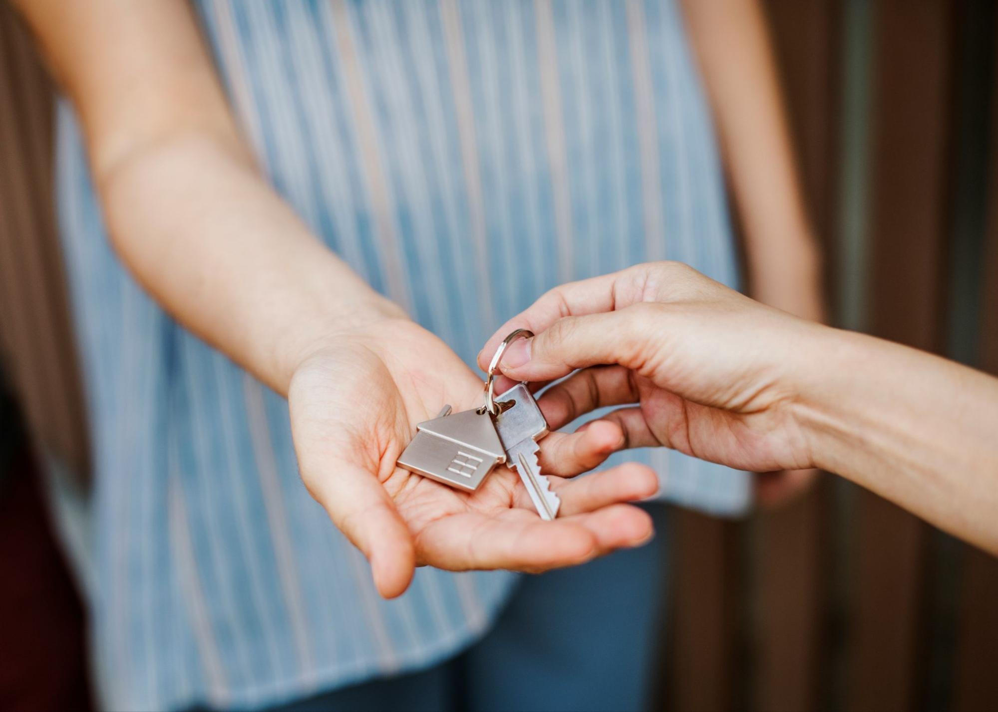 Keys Being Handed Over in a Real Estate Transaction