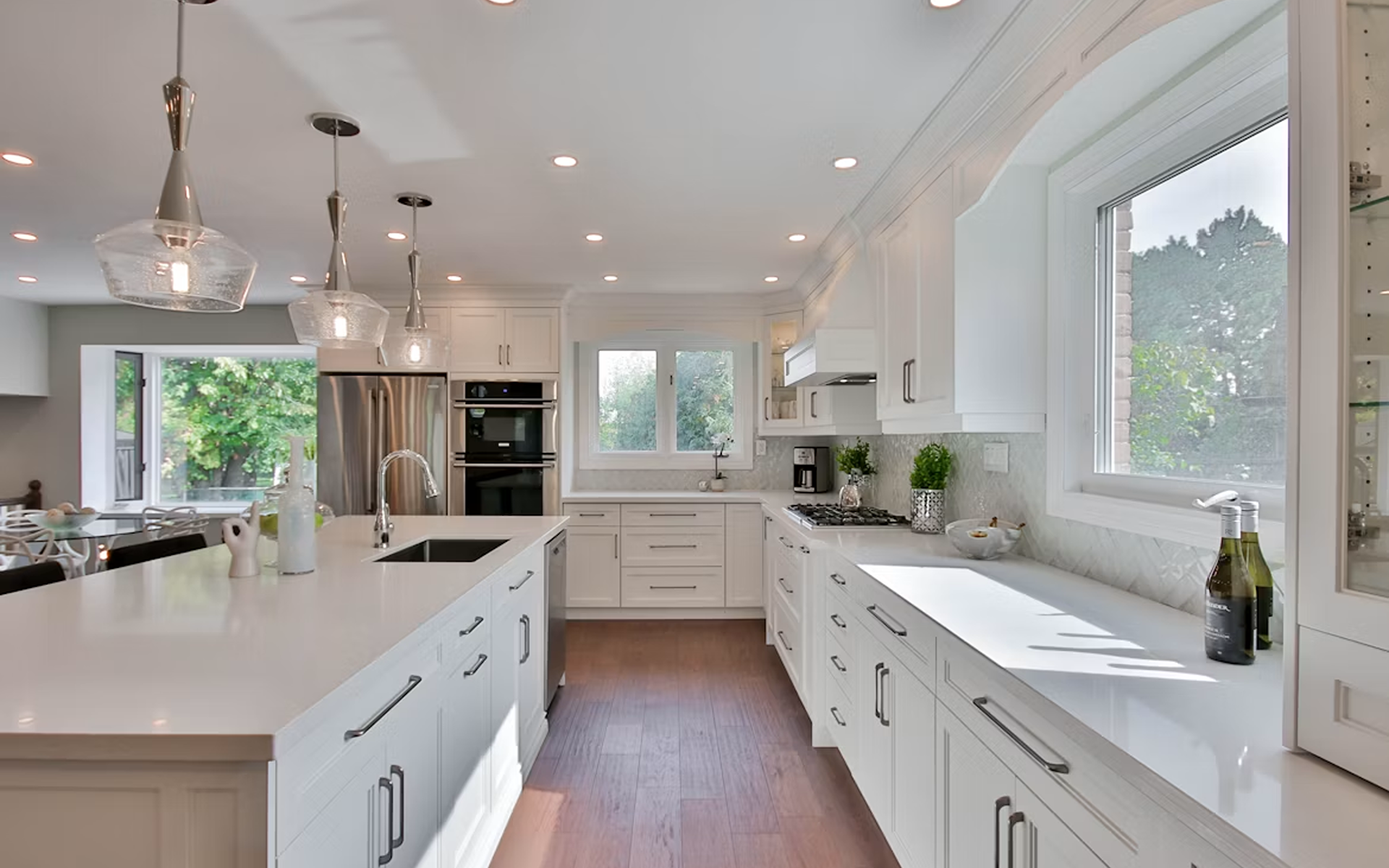Modern Kitchen with White Cabinets and Large Windows in a Real Estate Listing