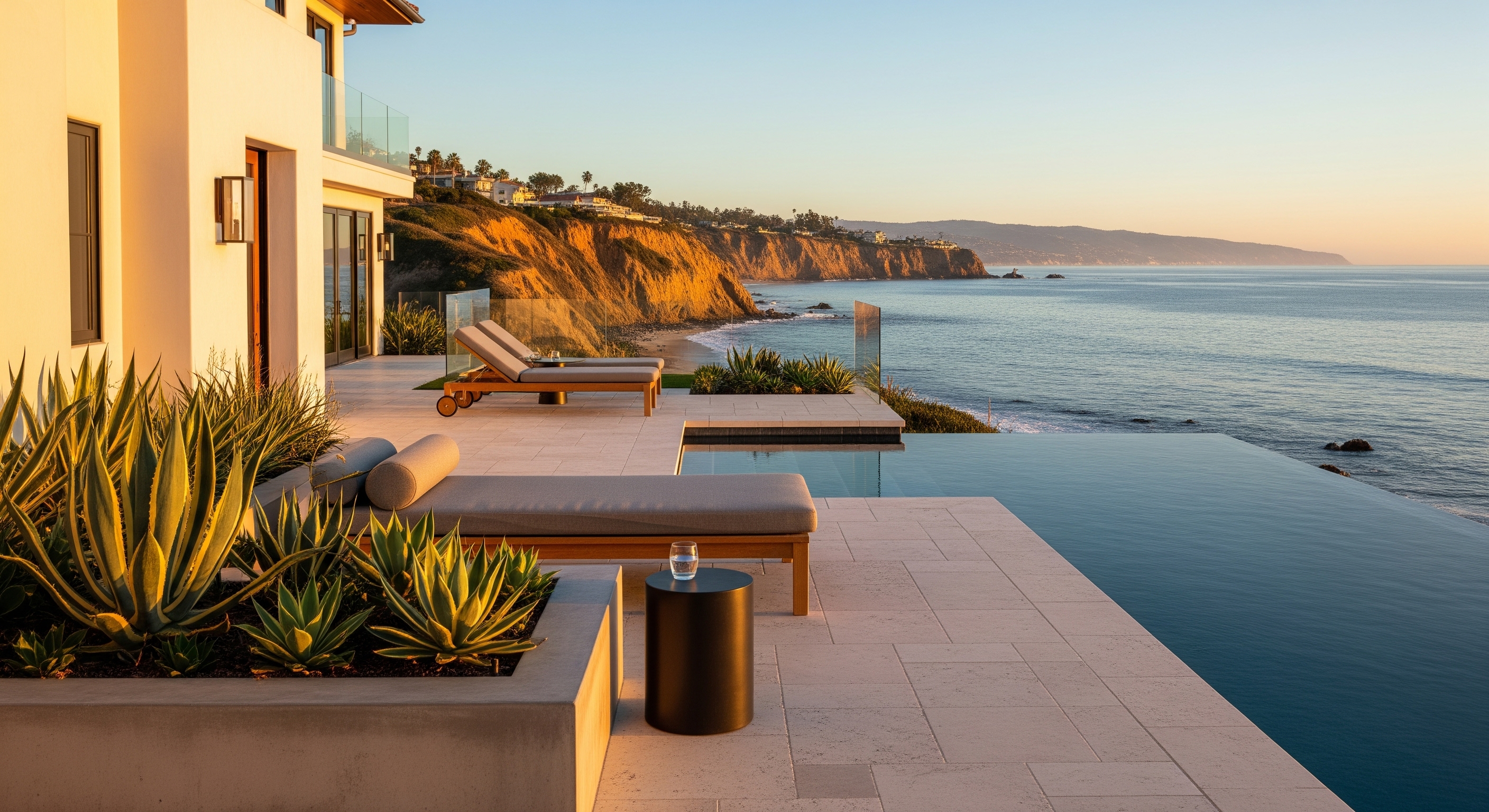Luxury Oceanfront Patio with Infinity Pool Overlooking Coastline at Sunset